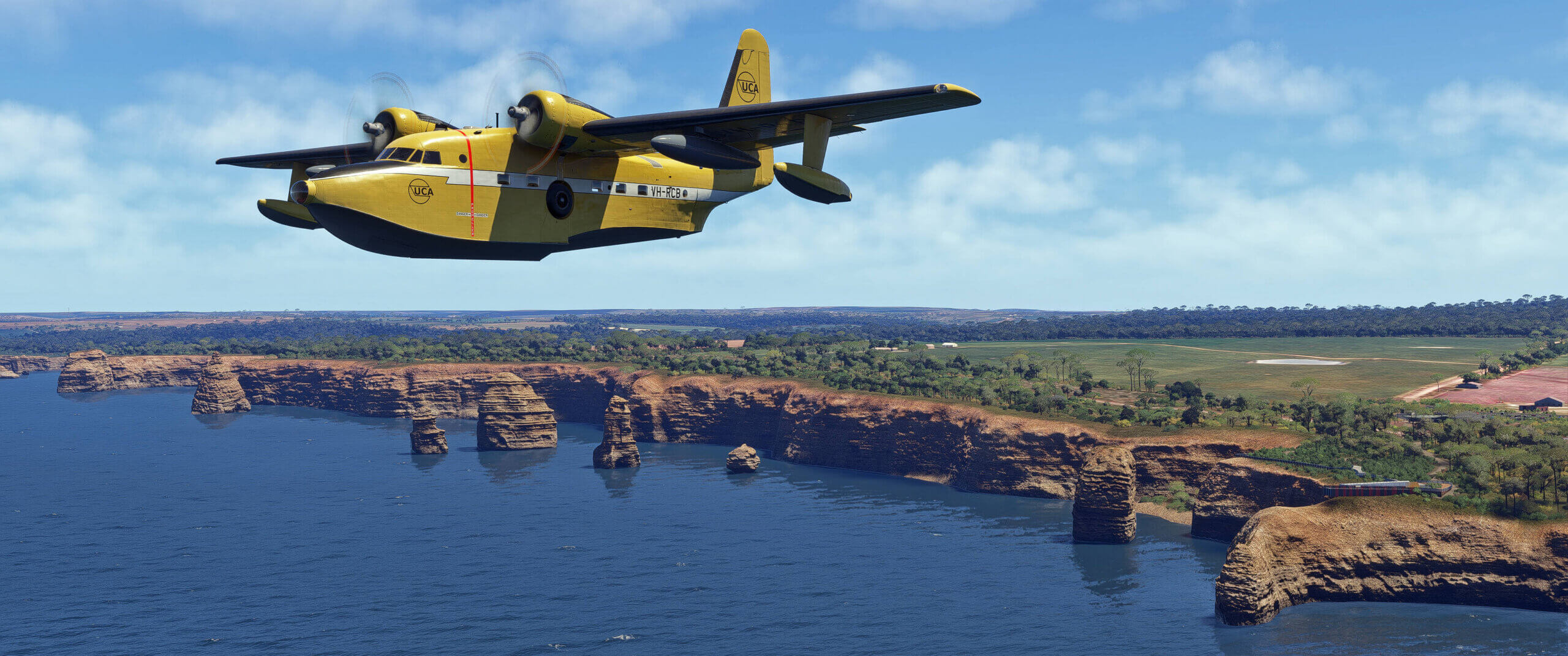 A high wing yellow prop aircraft flies away from a rocky coastline
