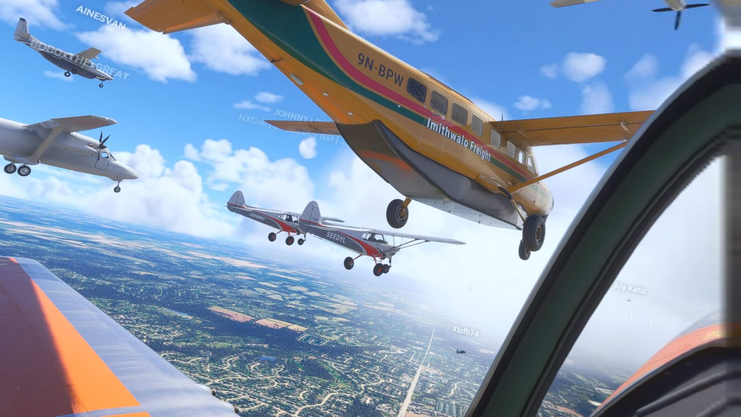 View from the cockpit of an aircraft with many planes flying in close formation out of the window
