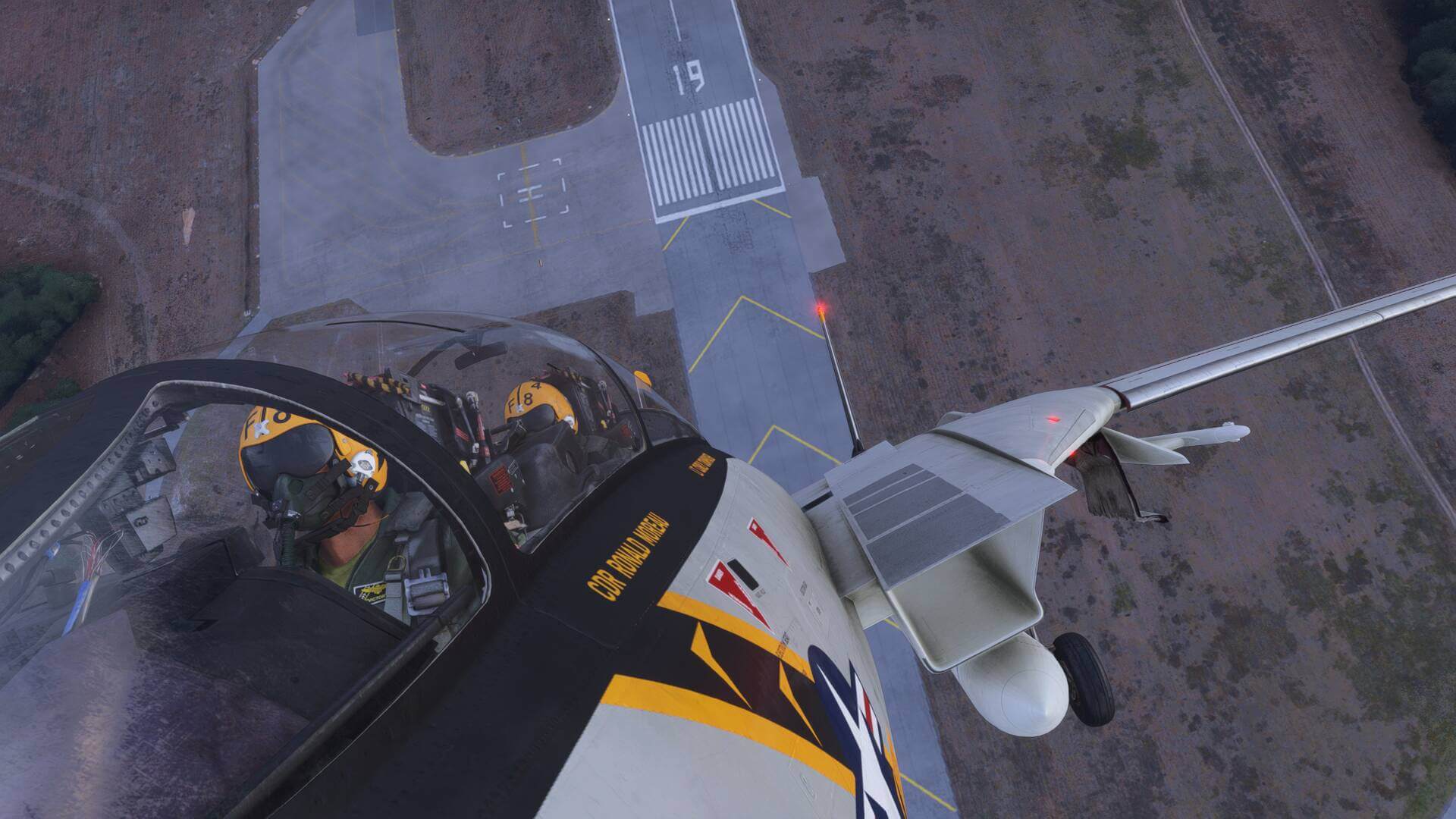 An F-14 pulls into a steep vertical climb