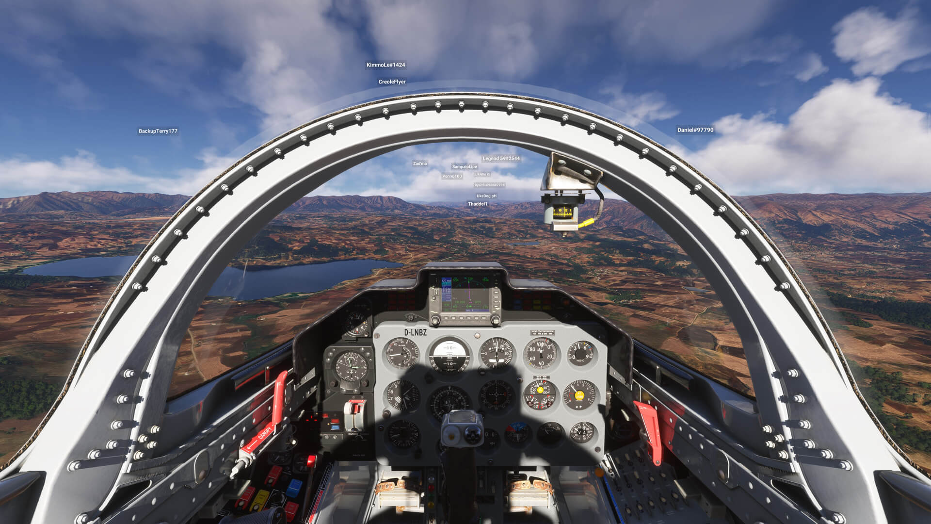 A jet aircraft cockpit view flying towards a valley