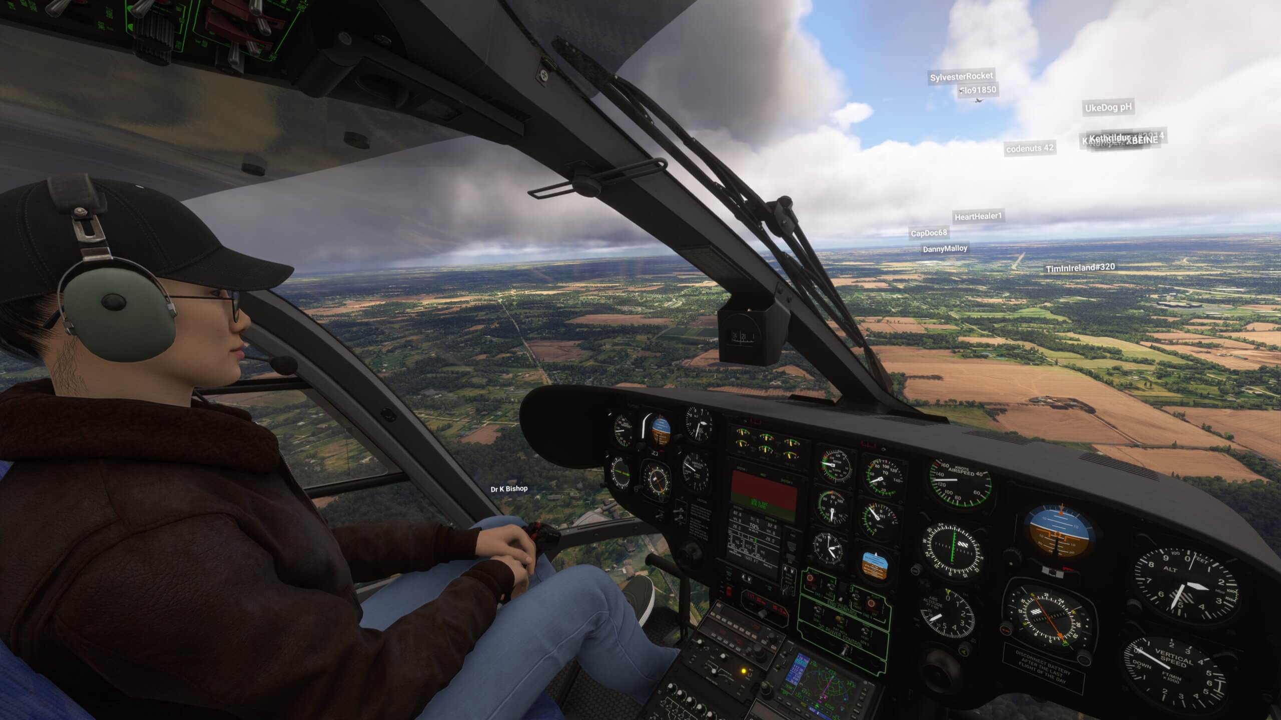 View from the cockpit of an EC135 cockpit flying low over fields