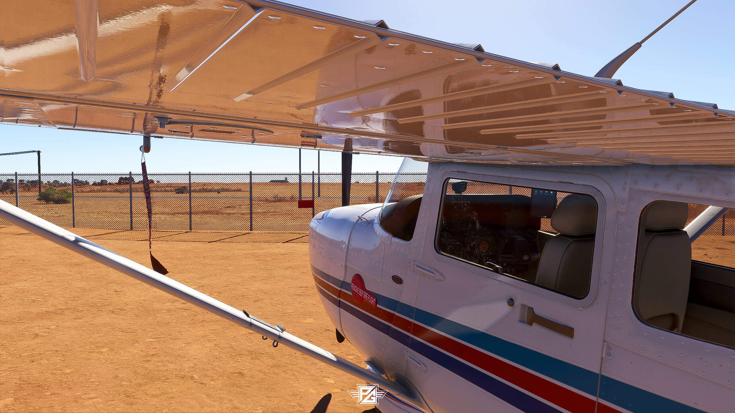 A Cessna sits idle on a dirt ramp with tags in place