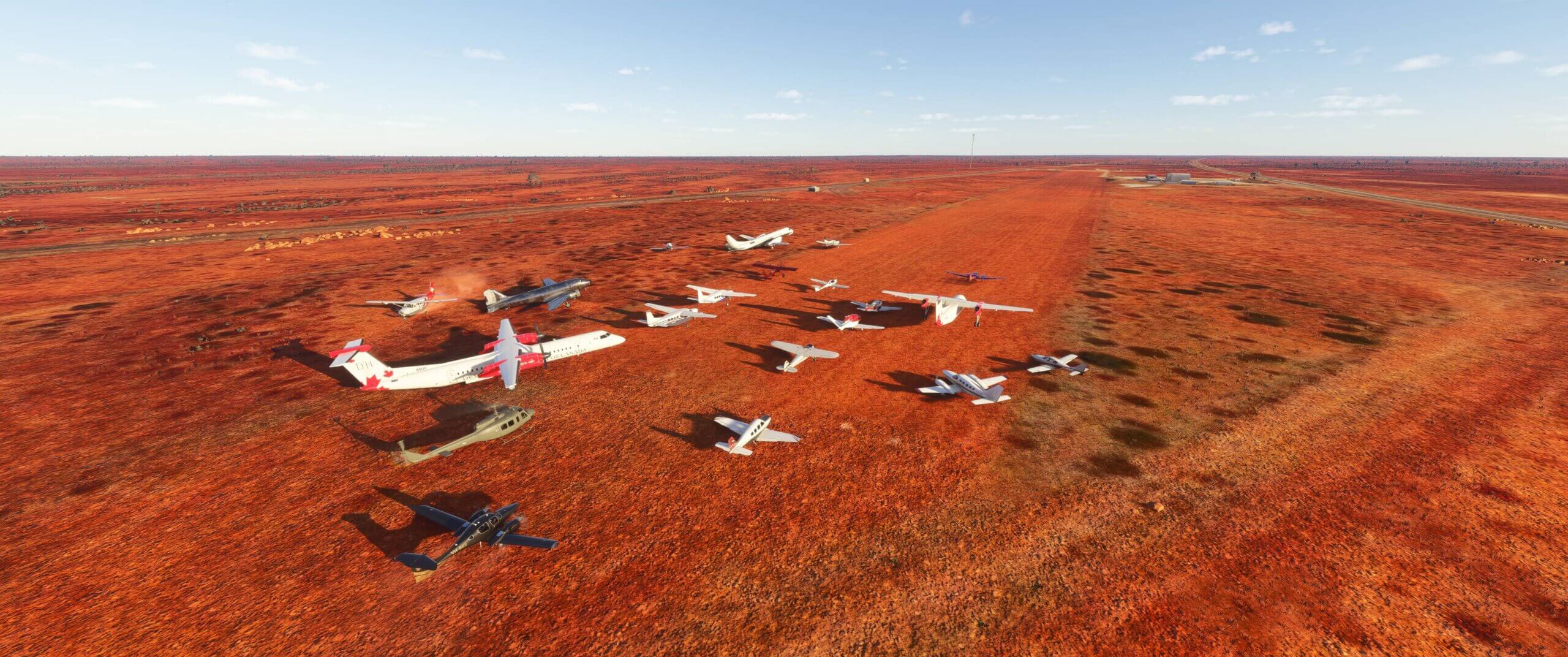 A gaggle of aircraft all line up for takeoff on a dirt strip runway