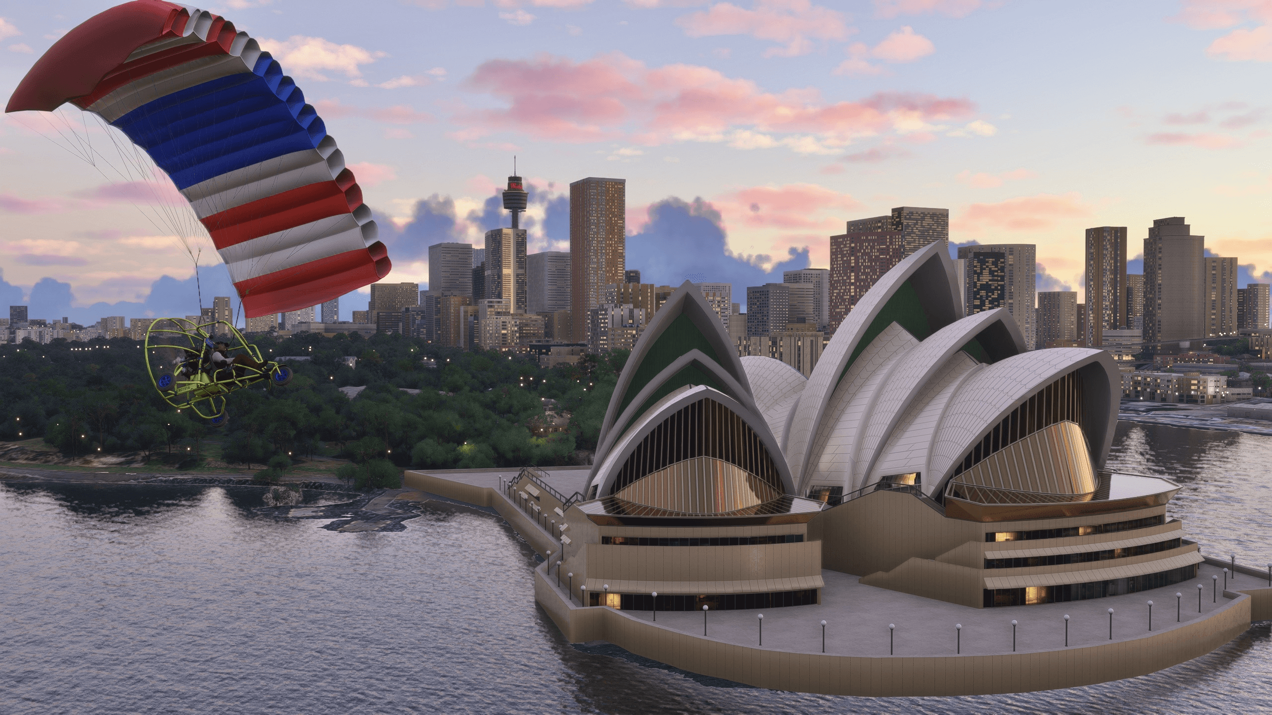A paraglider flies close to the Sydney Opera House during sunset