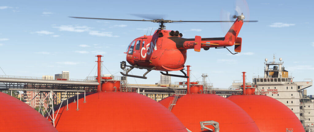 A red helicopter hovers over a large ship