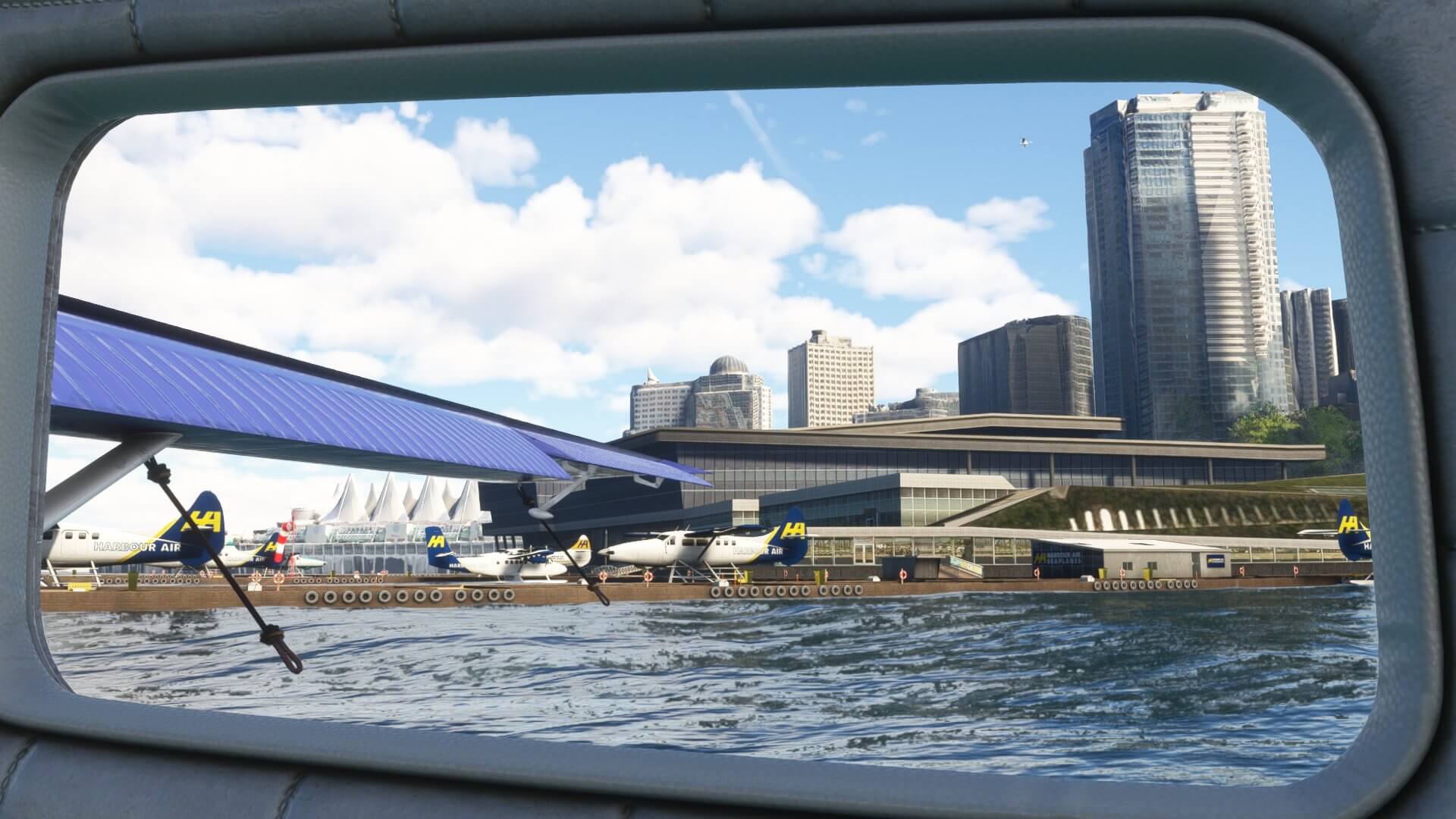 The view from the cabin of an aircraft on water looking at a busy airport ramp