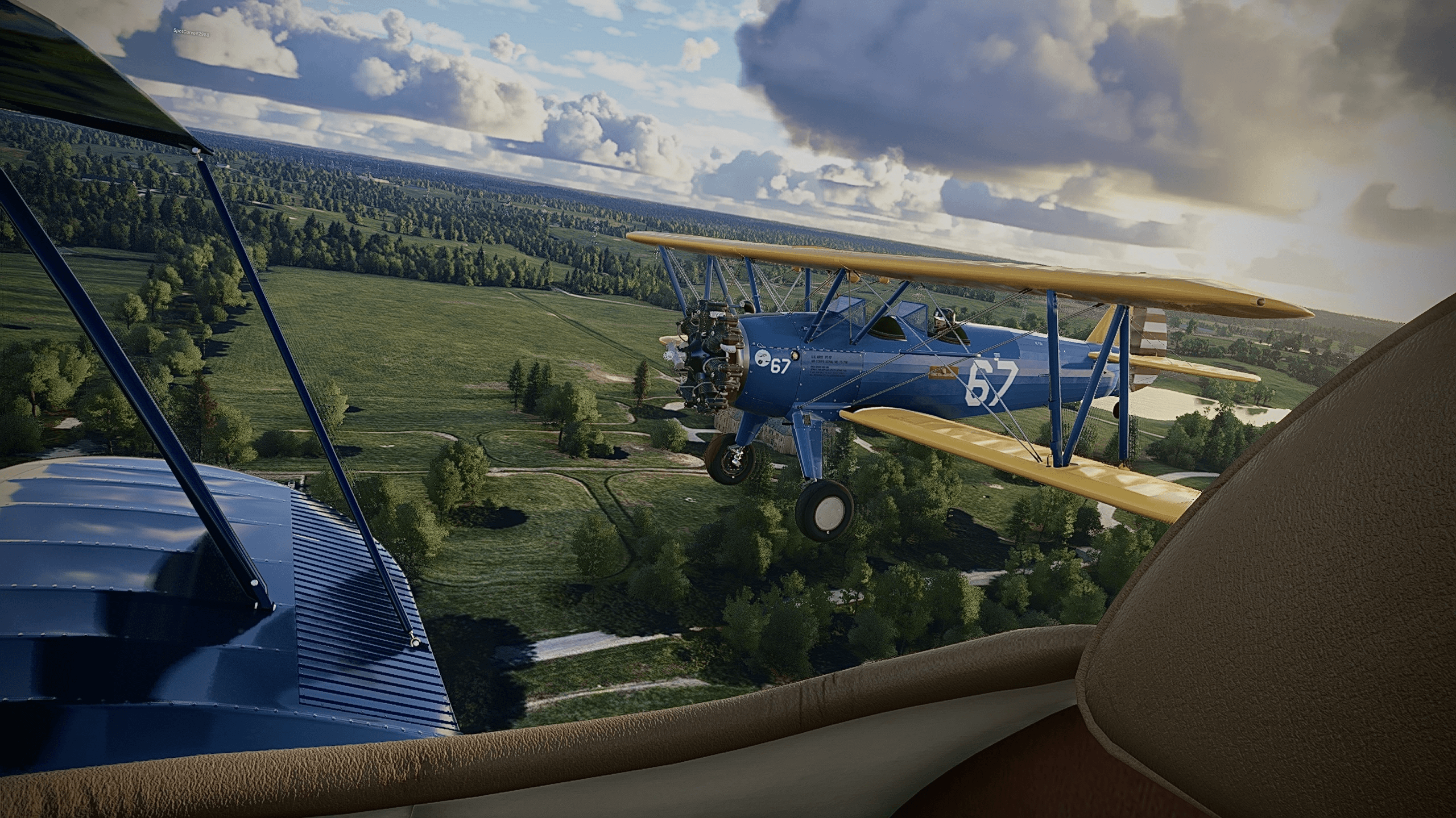 The view from the back seat of a dual wing propeller aircraft, flying in close formation with its counterpart