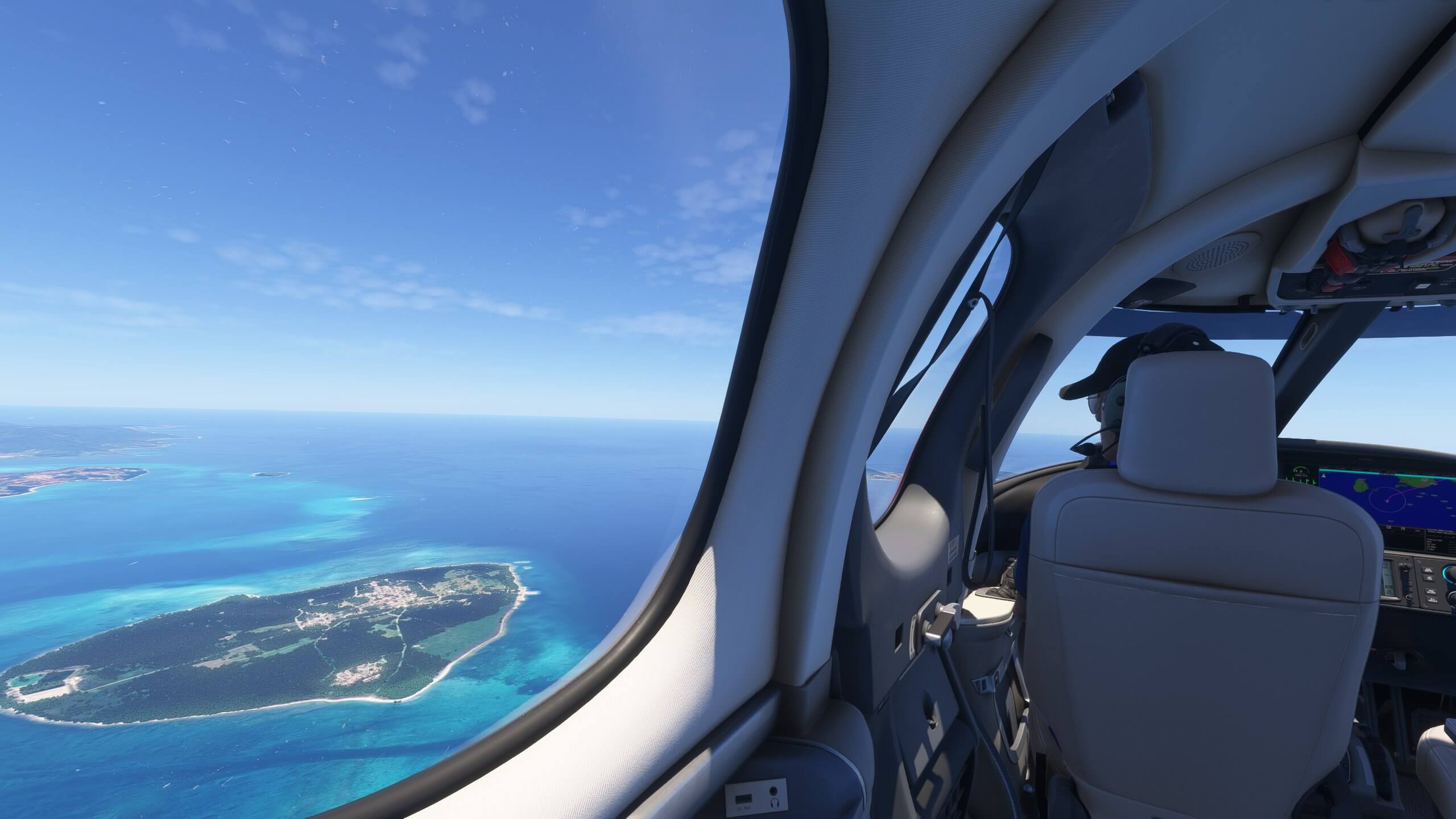 The view from the back seat of a private jet flying over islands