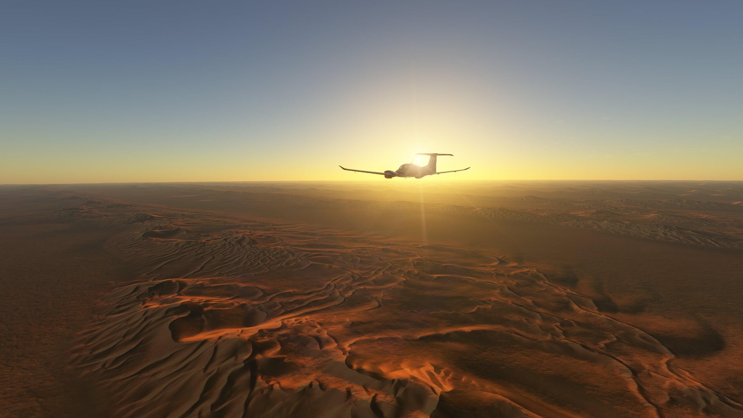 A Diamond propeller aircraft cruises over the desert at sunset