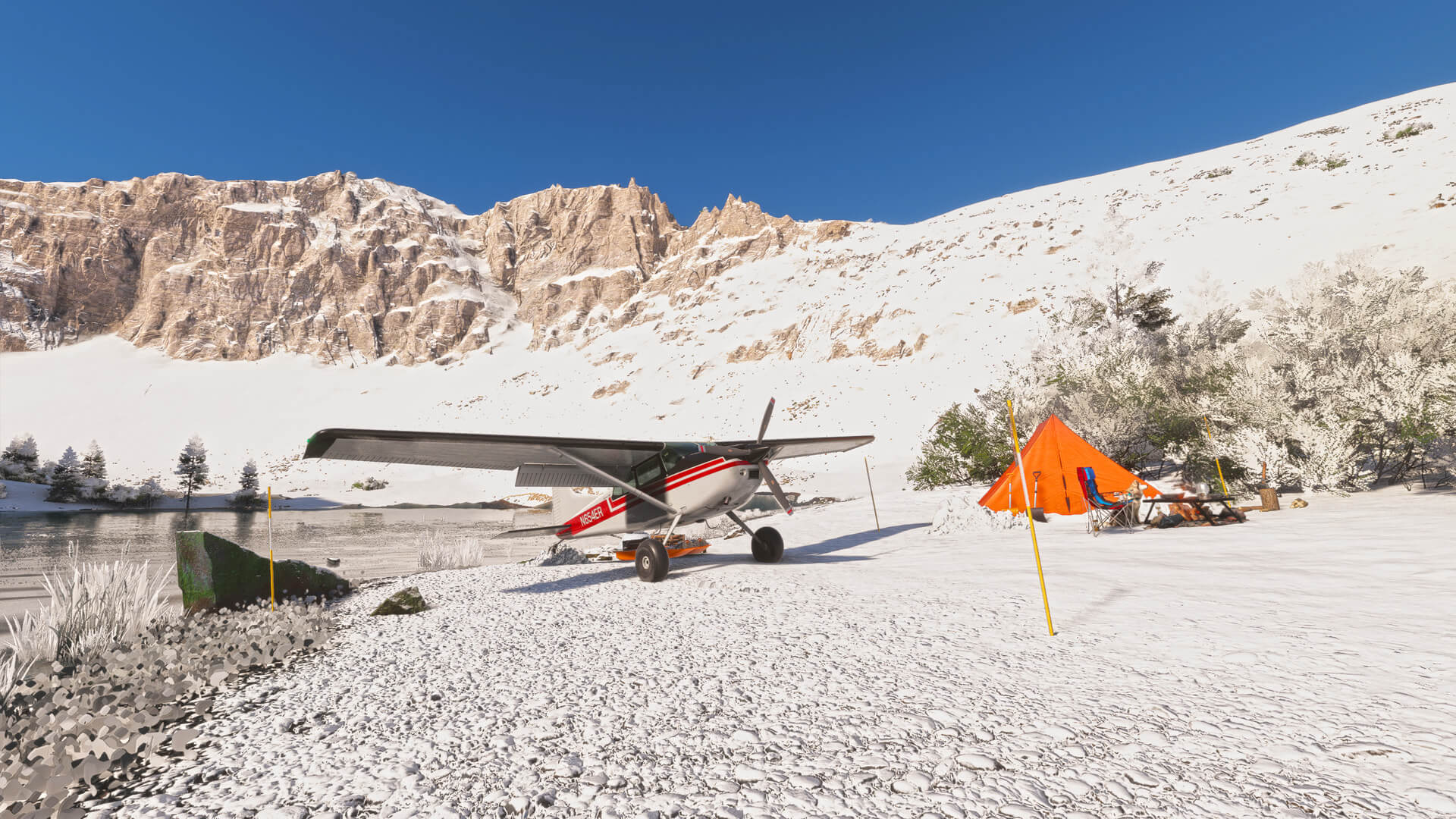 A red and white Cessna parked on snow with a tent next to it