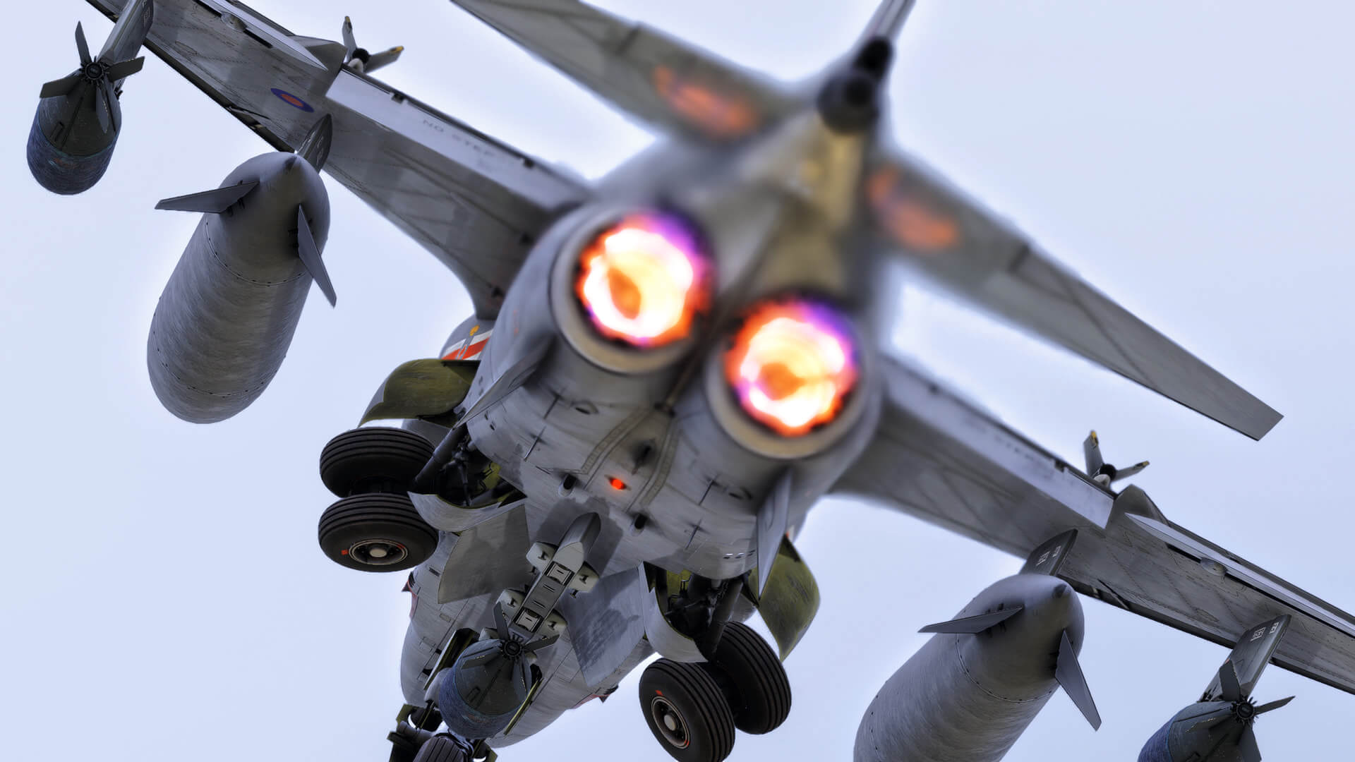 A fighter jet deploys landing gear with afterburner engaged