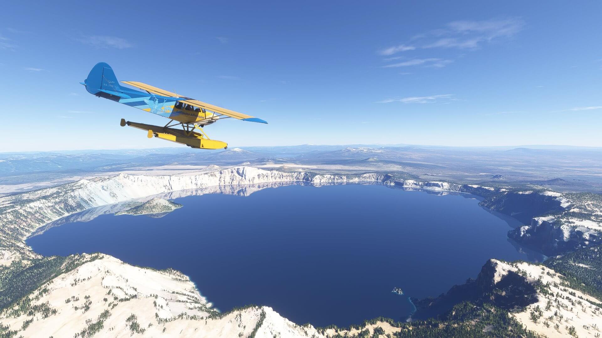 A high wing propeller aircraft flies over a large water bed in a US National Park