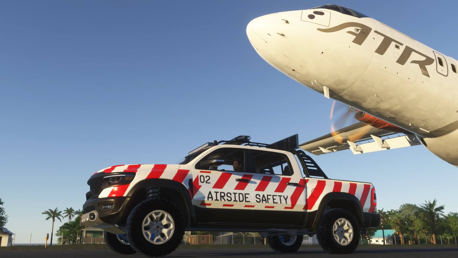 An ATR flies close overhead an Airside Safety car