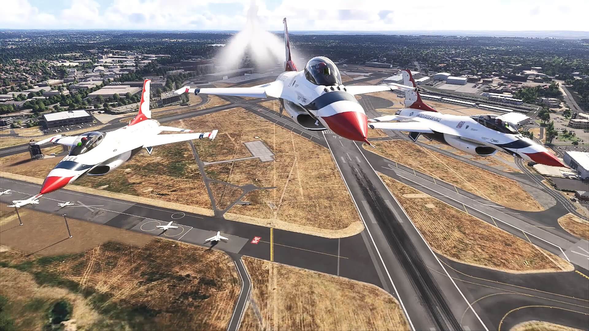 Three F-16's from the Thunderbirds fly in close formation over a runway