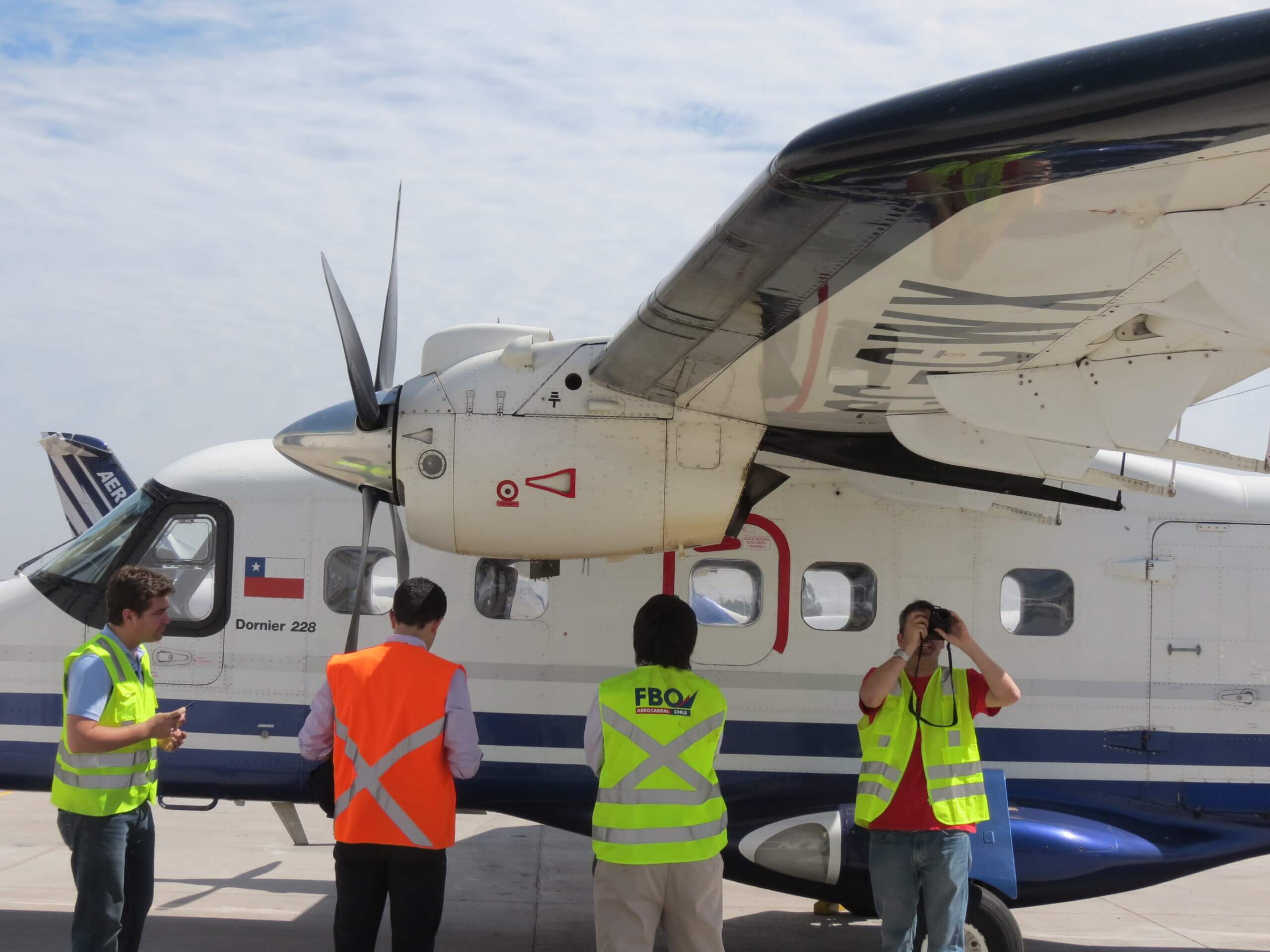 Carenado team members inspect a real DO228