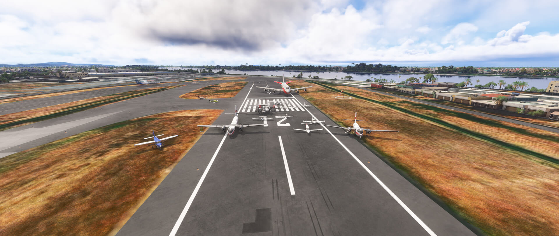 A group of aircraft line up for a group picture on a runway
