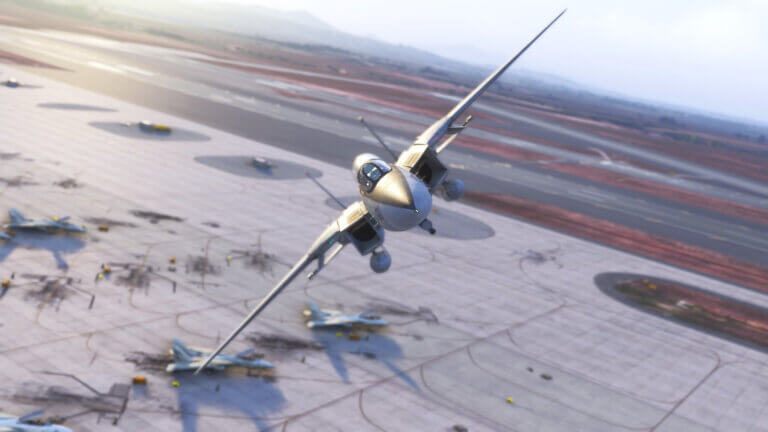 An F-14 banks heavily to the right while flying over the apron of a military airport