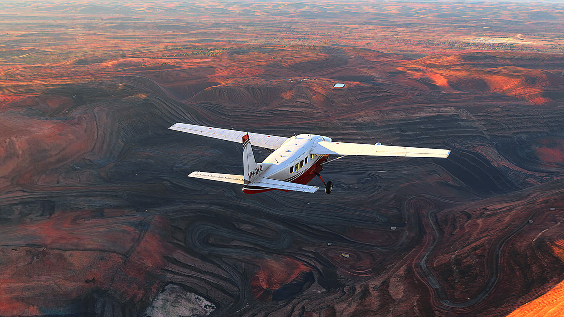 A red and white Cessna Caravan flies over a desert