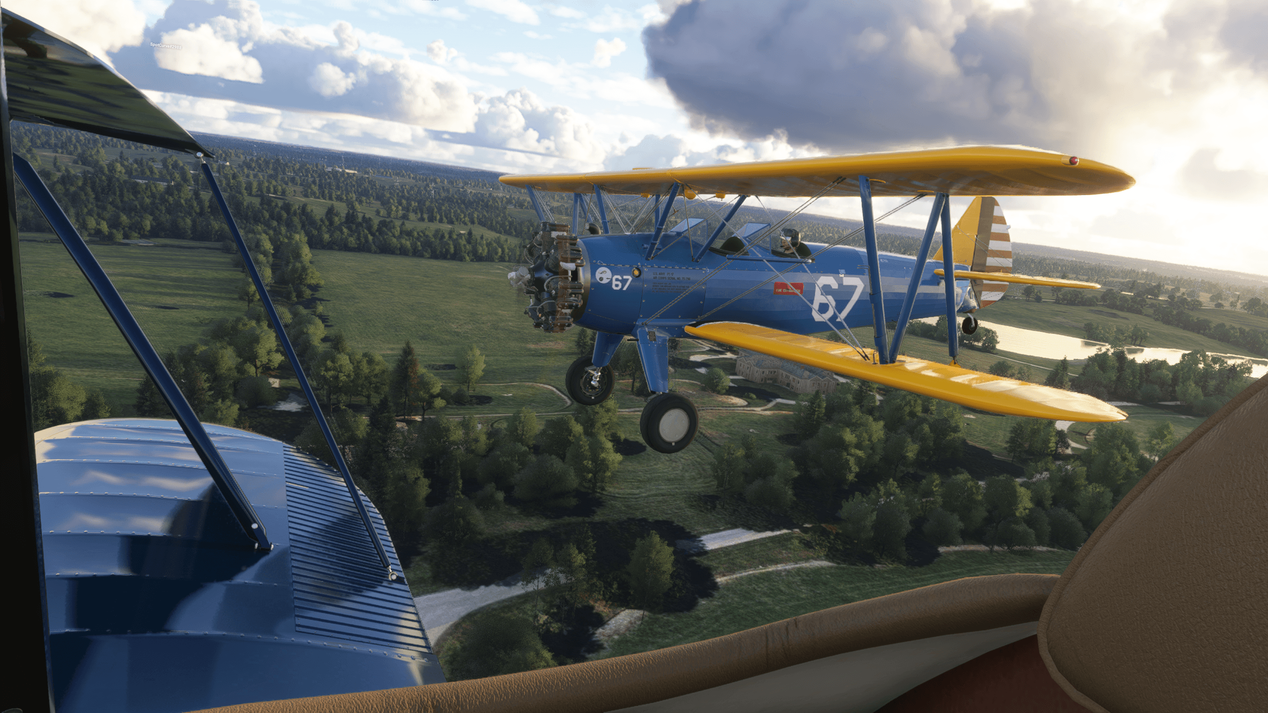Two dual-wing blue and yellow propeller aircraft fly in close formation