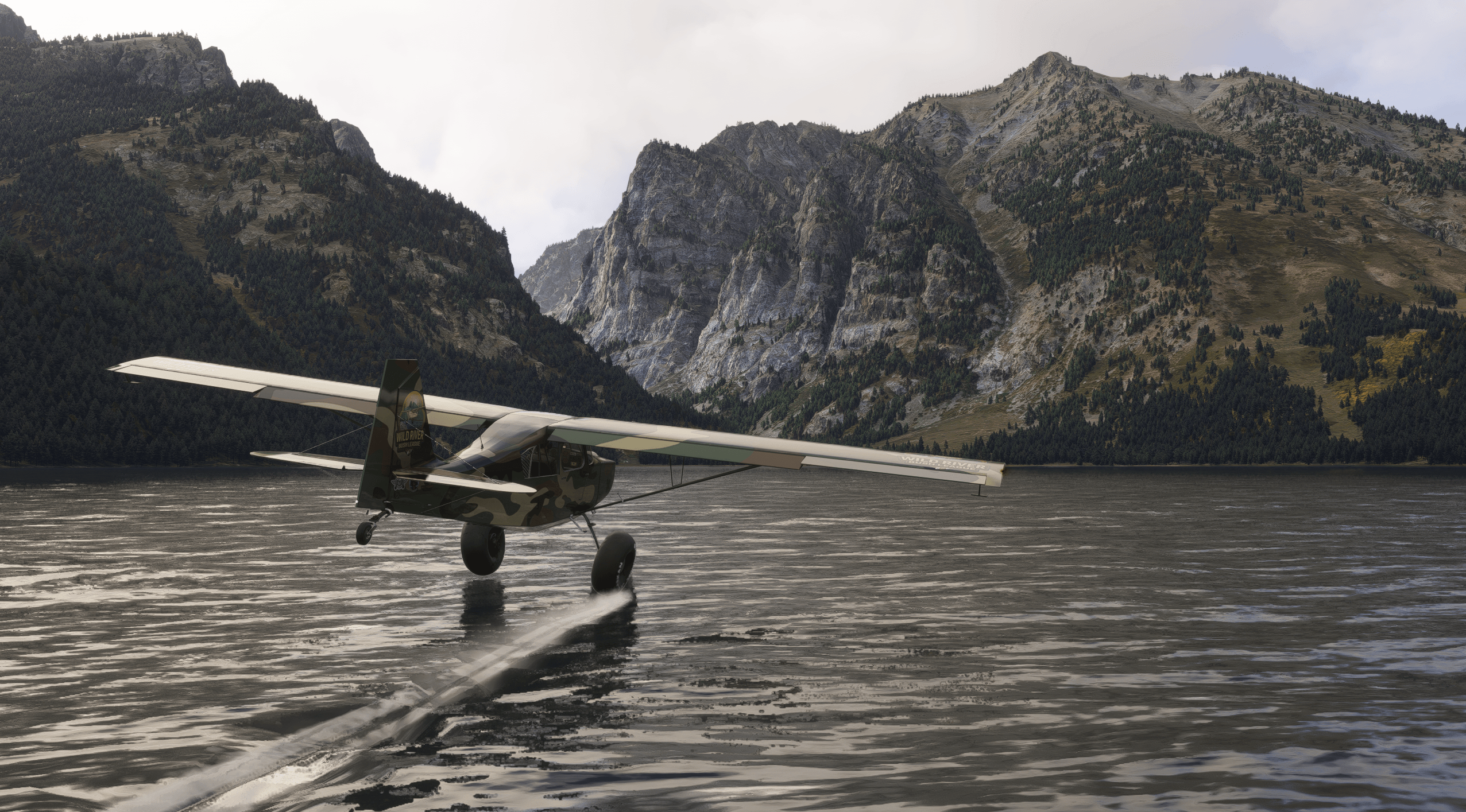 A high wing propeller aircrafts led wheel makes contact with water while flying low over a lakebed