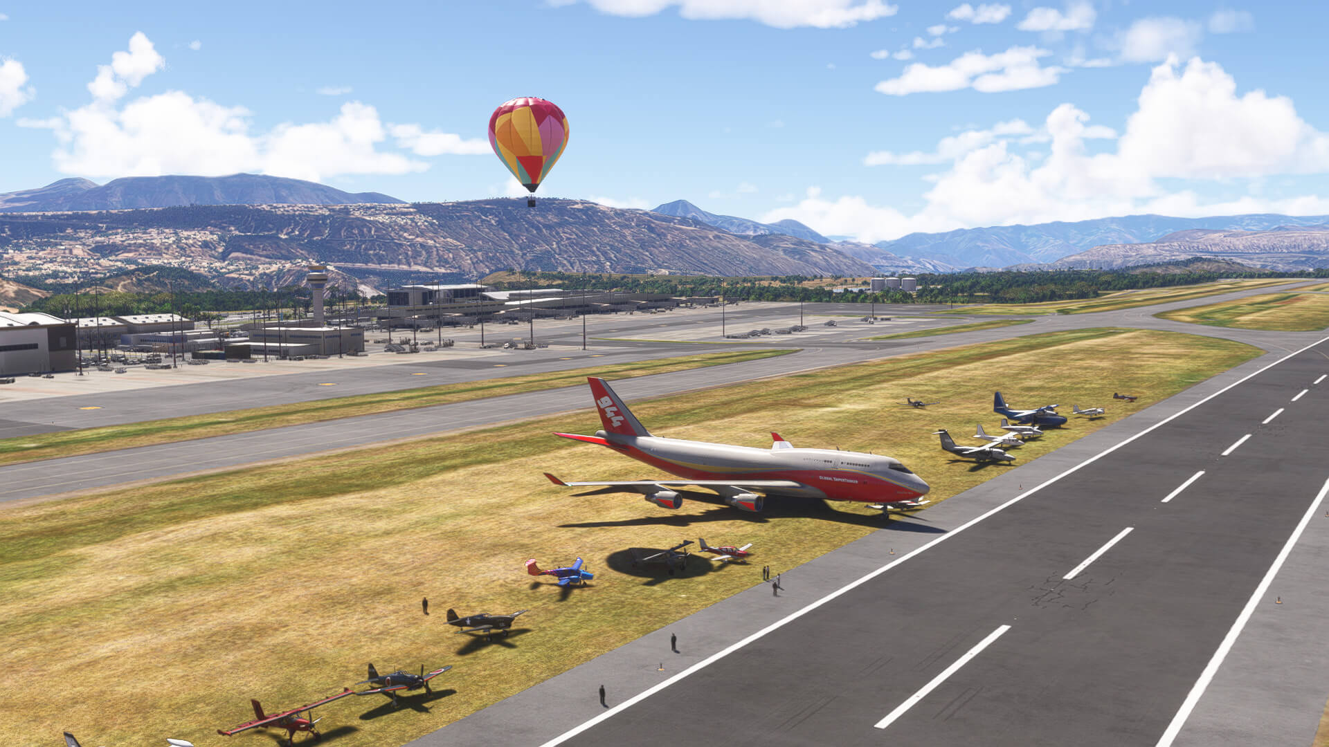 A group of aircraft line up for a group picture on a runway