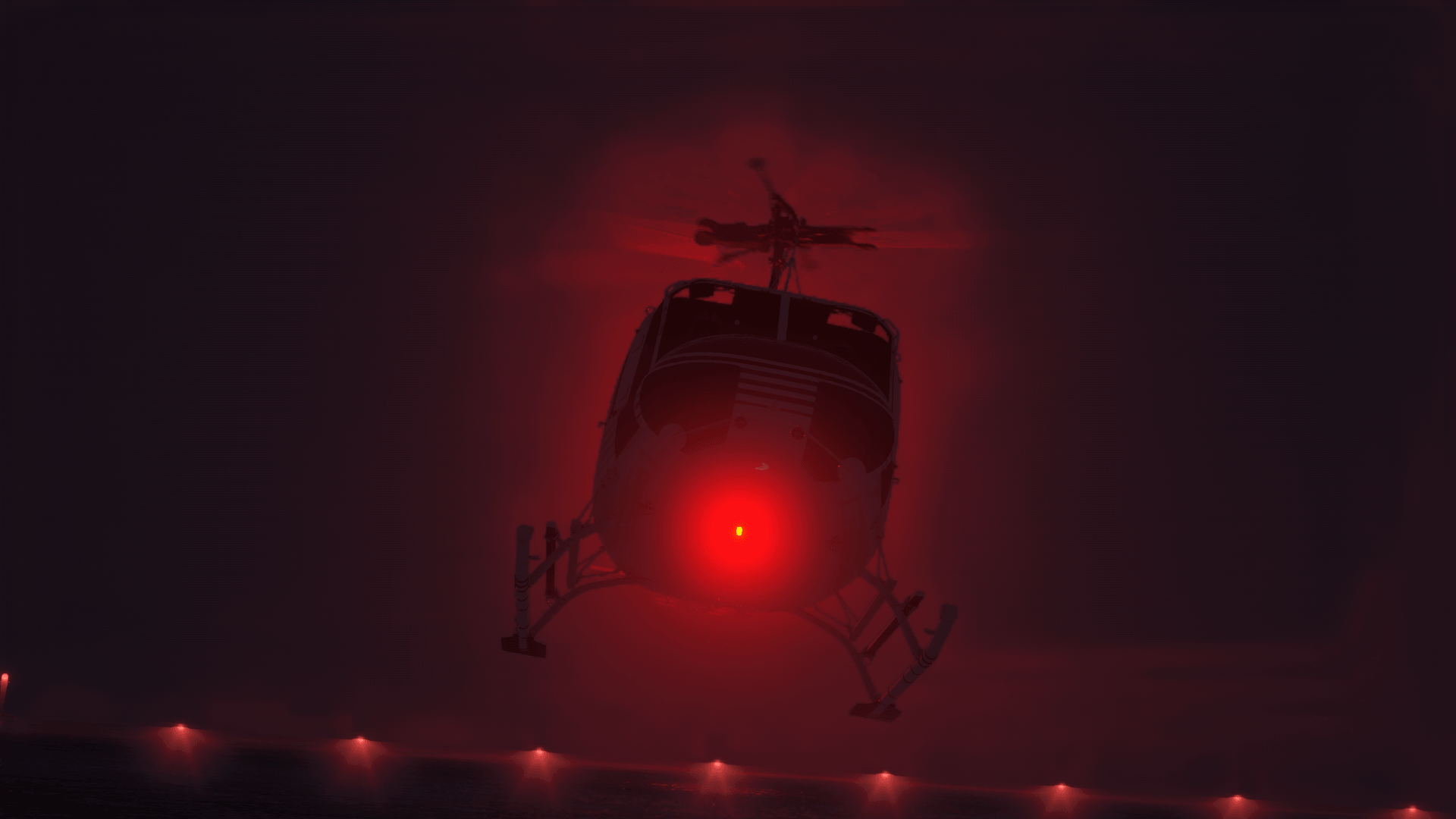 A helicopter with red beacon light flashing comes into land