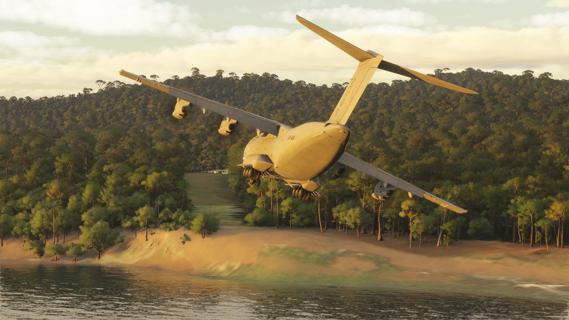 An Airbus A400M banks to the right to line up with a grass runway strip surrounded by trees