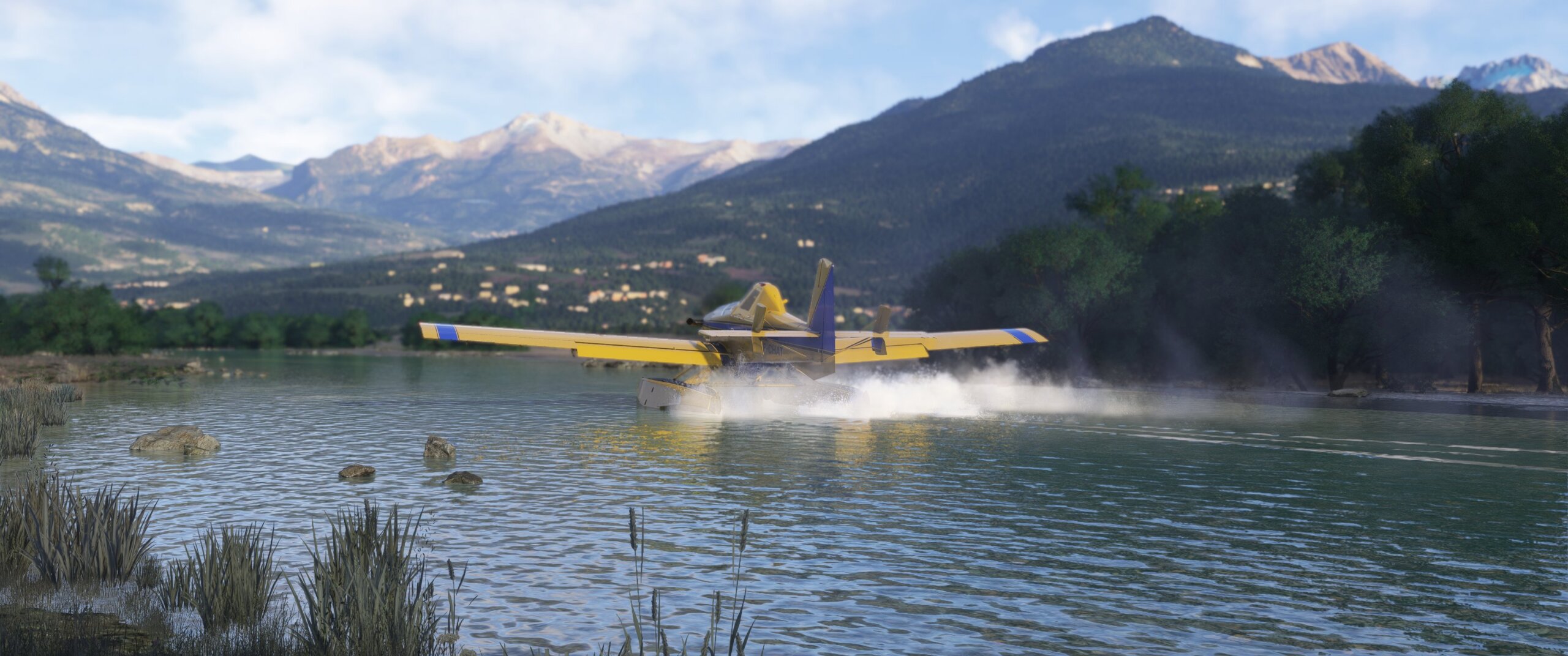 A yellow and blue fixed wing propeller aircraft skates across water