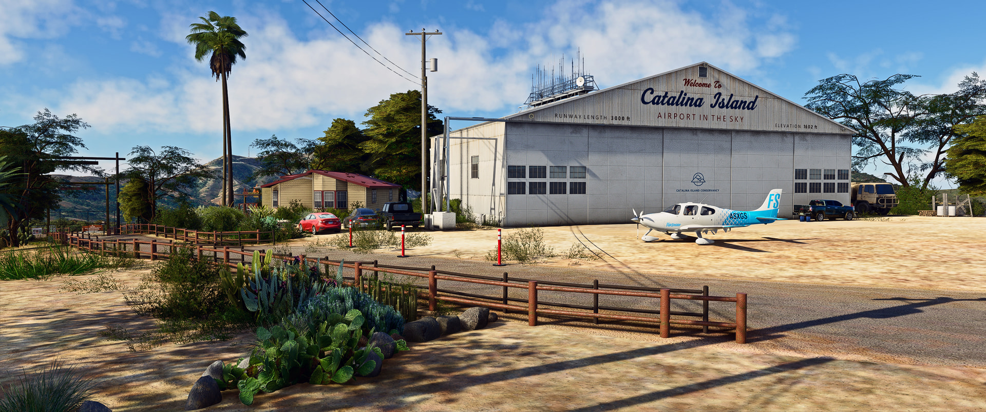 A small general aviation aircraft sits idle outside an airport hangar at Catalina Island airport