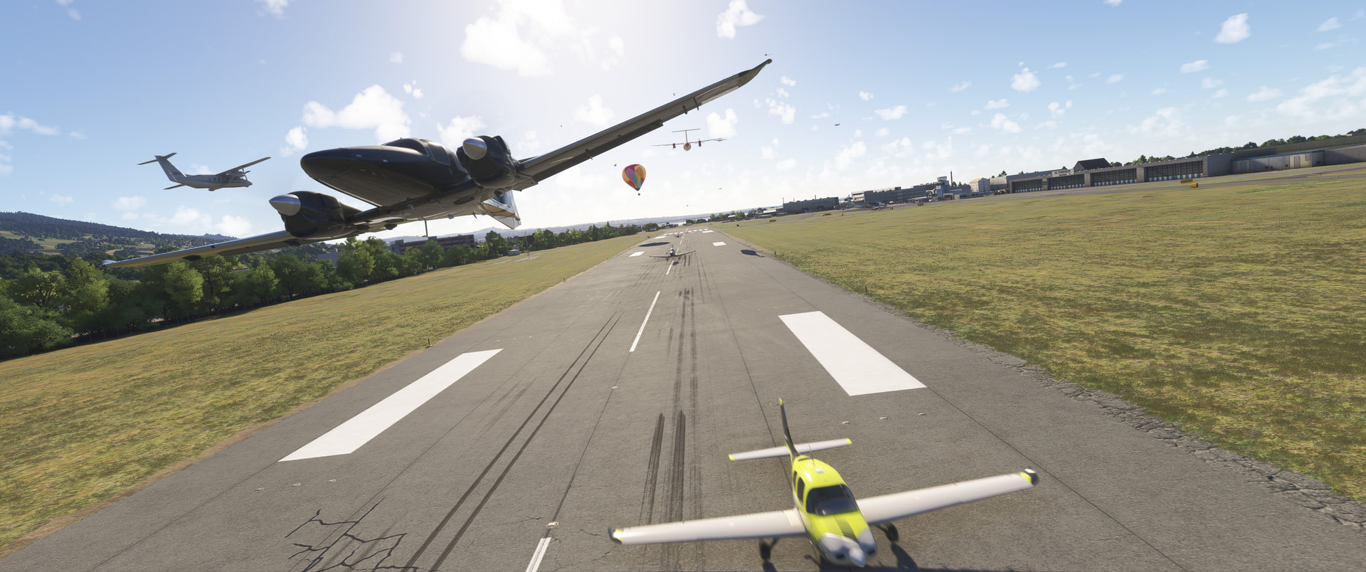 Many aircraft flying over a runway in opposite directions
