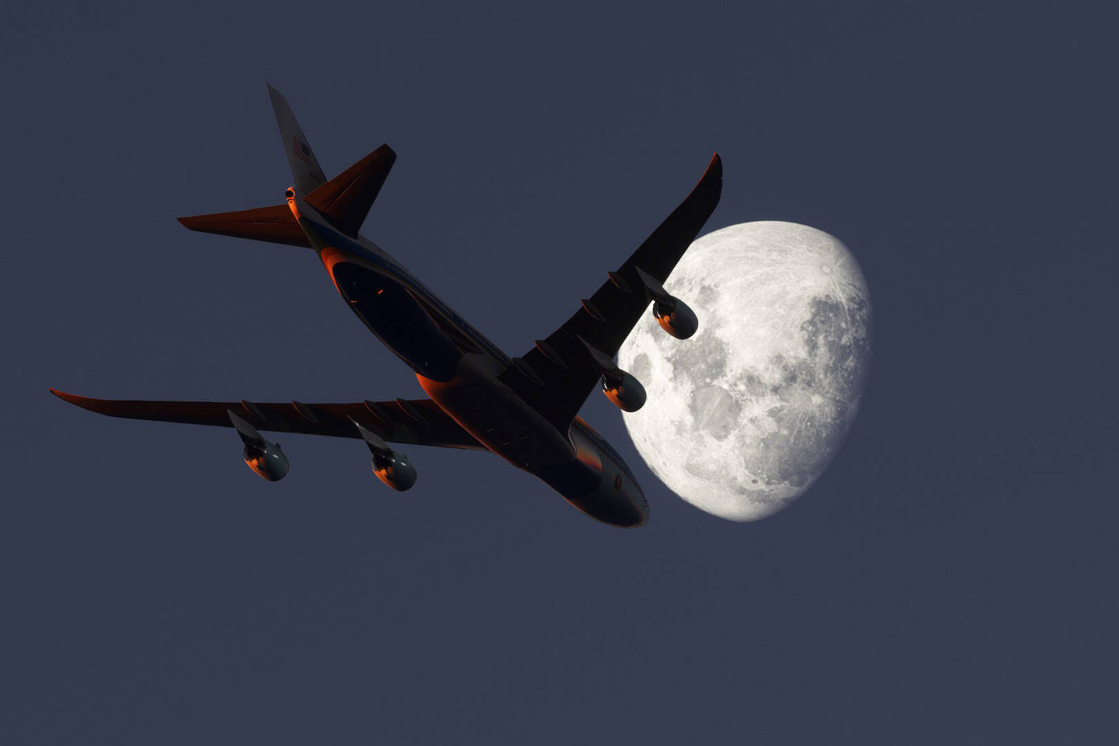 A Boeing 747 silhouetted by the moon