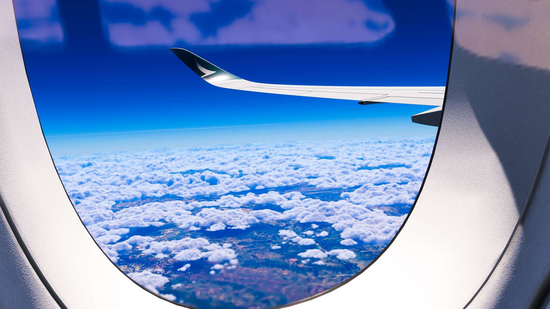 The wing view of an Airbus A350 from the cabin during cruise
