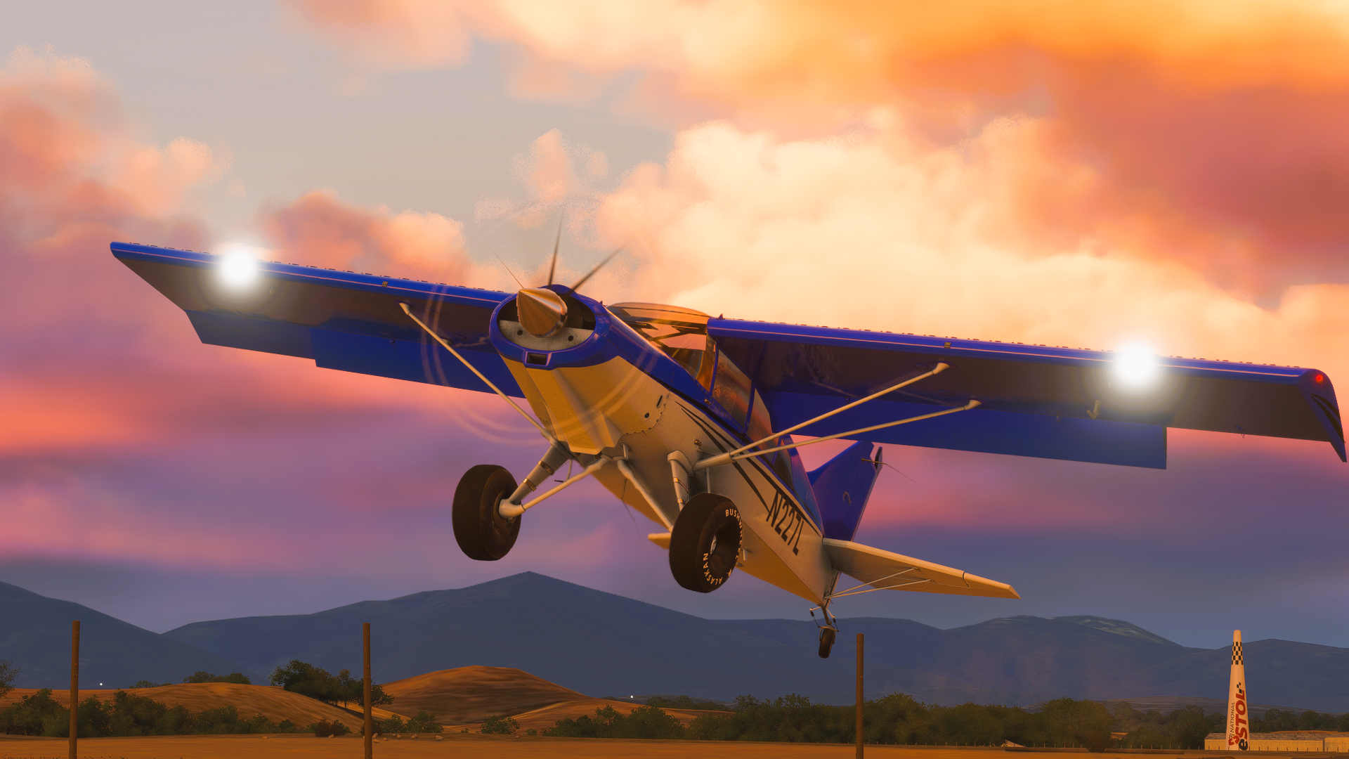 A high wing blue STOL aircraft takes off during golden hour