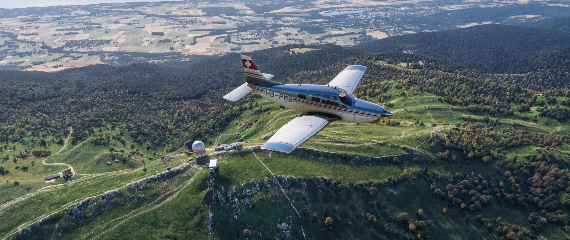 A low wing propeller aircraft flies over an outpost
