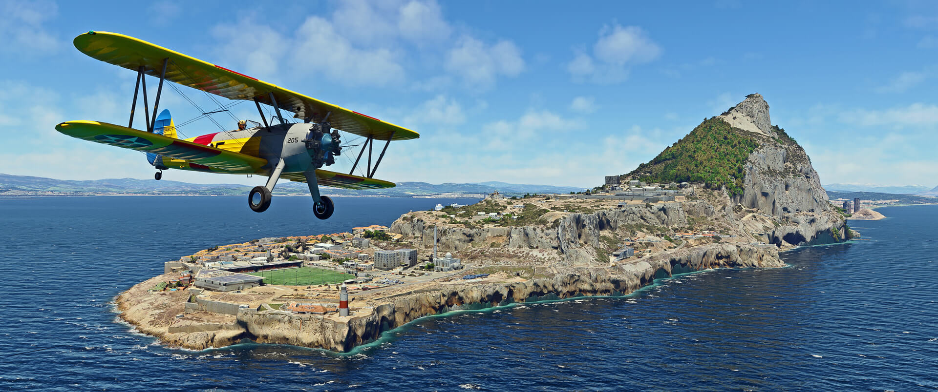 A bi-plane flies near the coast of Gibraltar