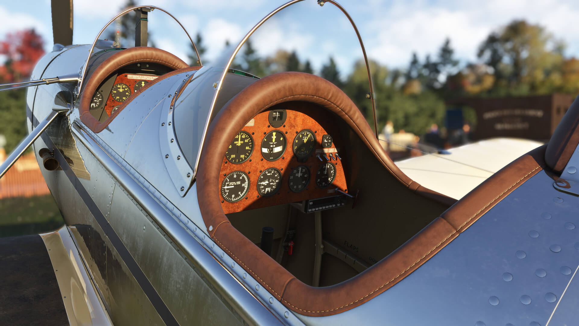 The cockpit of a vintage aircraft with metal fuselage