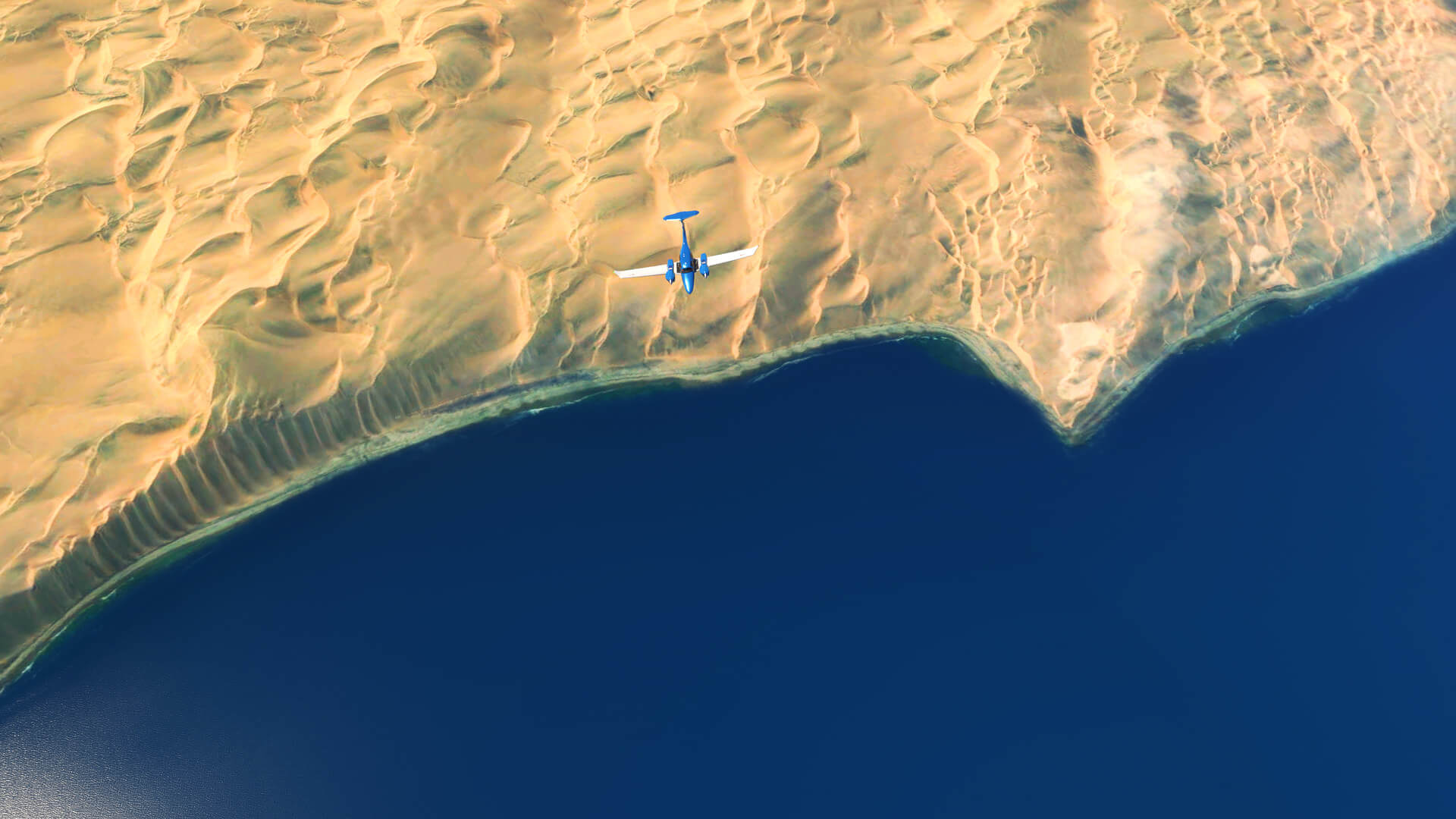 A DA-62 flies over a desert coastline