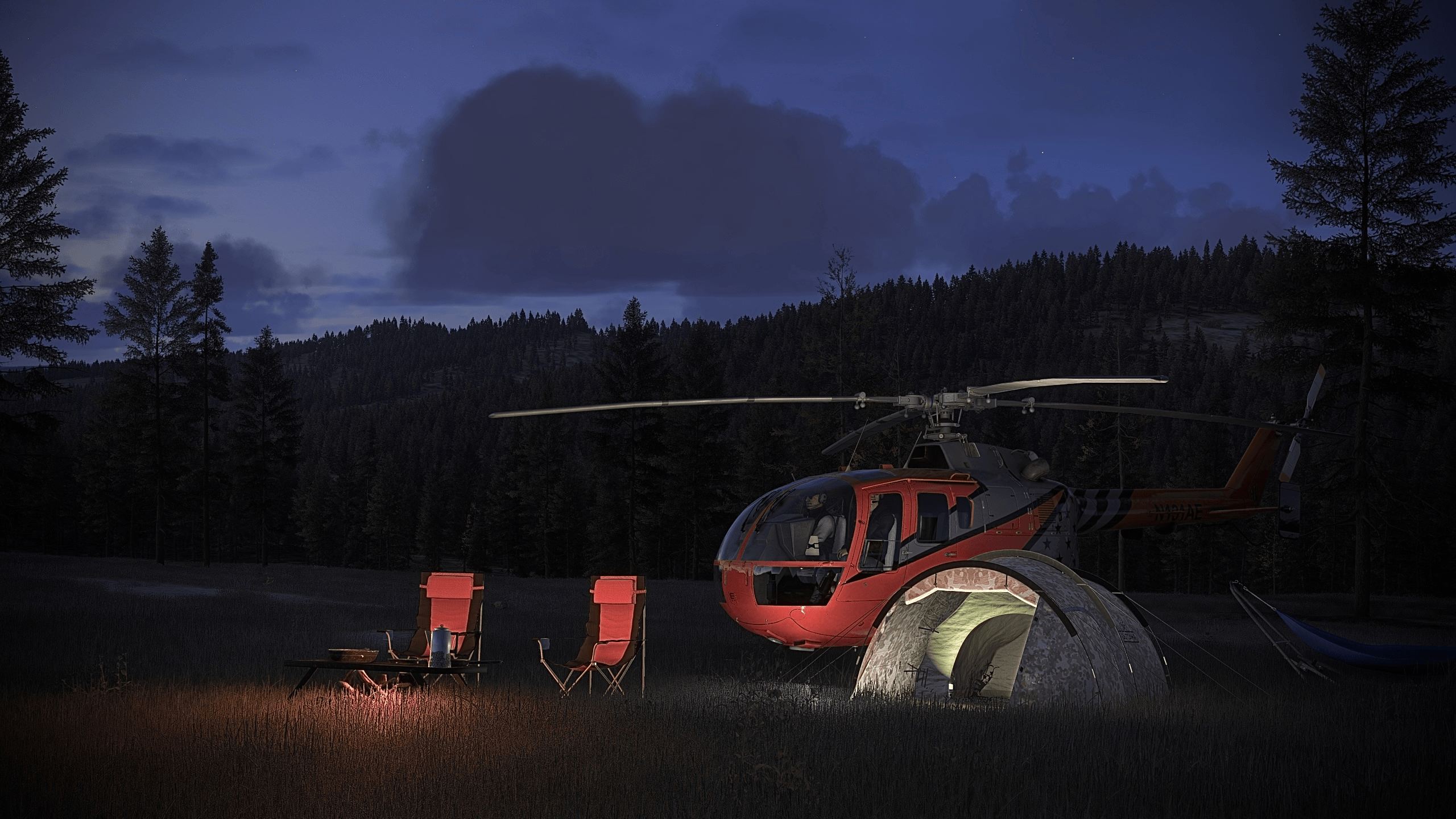 A helicopter sits next to a campsite at night